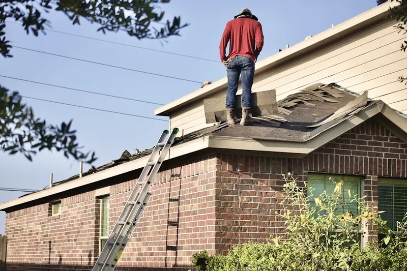 Professional roofer working on a residential roof in Centennial Manor